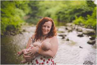 Shawna breastfeeding Zephyr near a creek in the woods